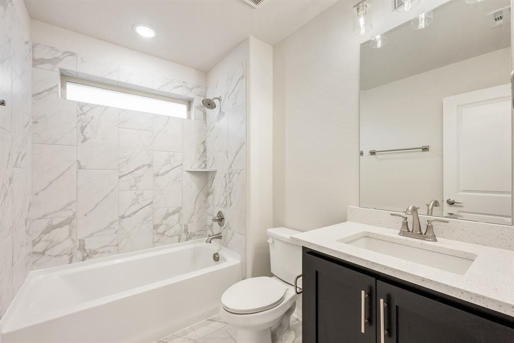 1113 Cardinal Drive Midlothian, TX 76065 - Photo 30 of 34 a bathroom with a granite countertop sink toilet and shower