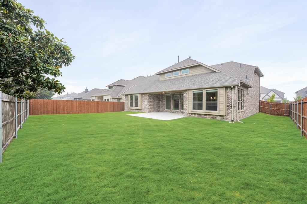 1113 Cardinal Drive Midlothian, TX 76065 - Photo 32 of 34 a front view of a house with a garden