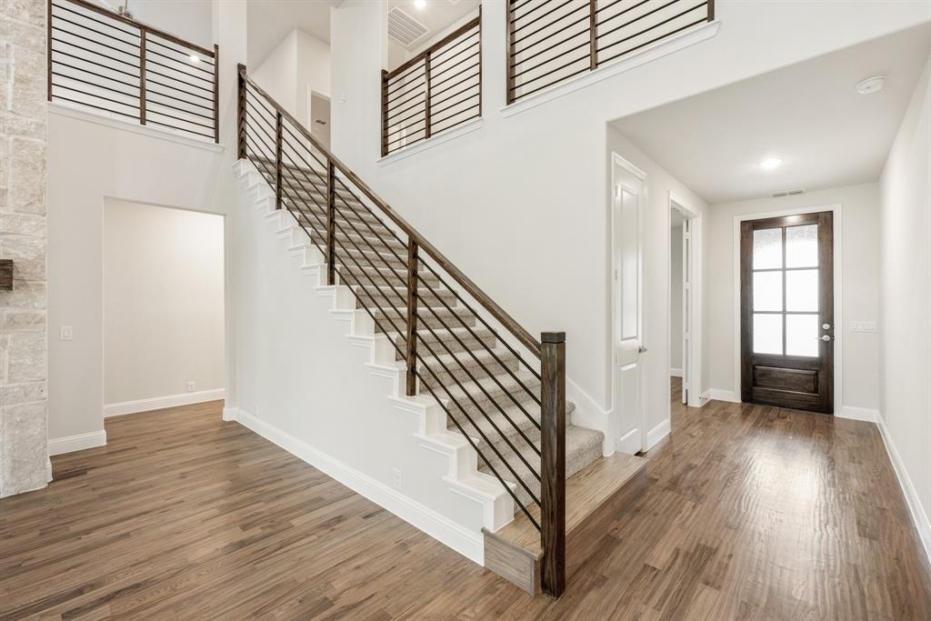 1113 Cardinal Drive Midlothian, TX 76065 - Photo 5 of 34 a view of a hallway with wooden floor and stairs