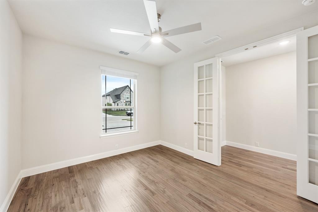 1113 Cardinal Drive Midlothian, TX 76065 - Photo 6 of 34 an empty room with wooden floor and windows