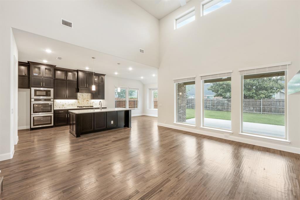 1113 Cardinal Drive Midlothian, TX 76065 - Photo 8 of 34 a view of a kitchen with kitchen island a sink stainless steel appliances and cabinets