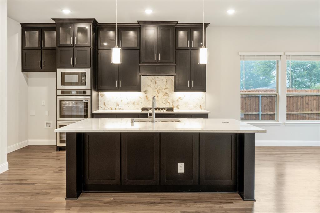 1113 Cardinal Drive Midlothian, TX 76065 - Photo 10 of 34 a kitchen with stainless steel appliances a sink and cabinets
