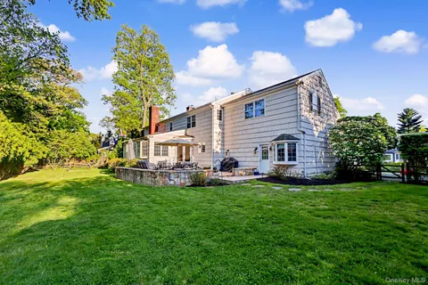 a view of a house with a yard and sitting area