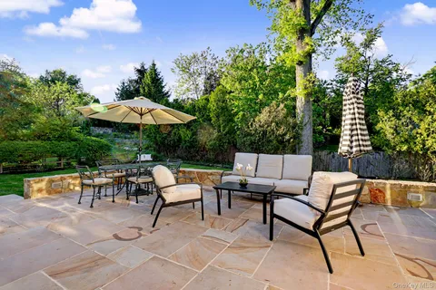 a backyard of a house with table and chairs