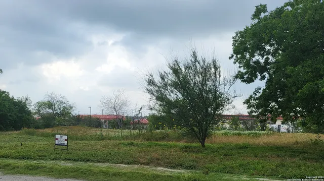 a view of outdoor space with green field and trees all around