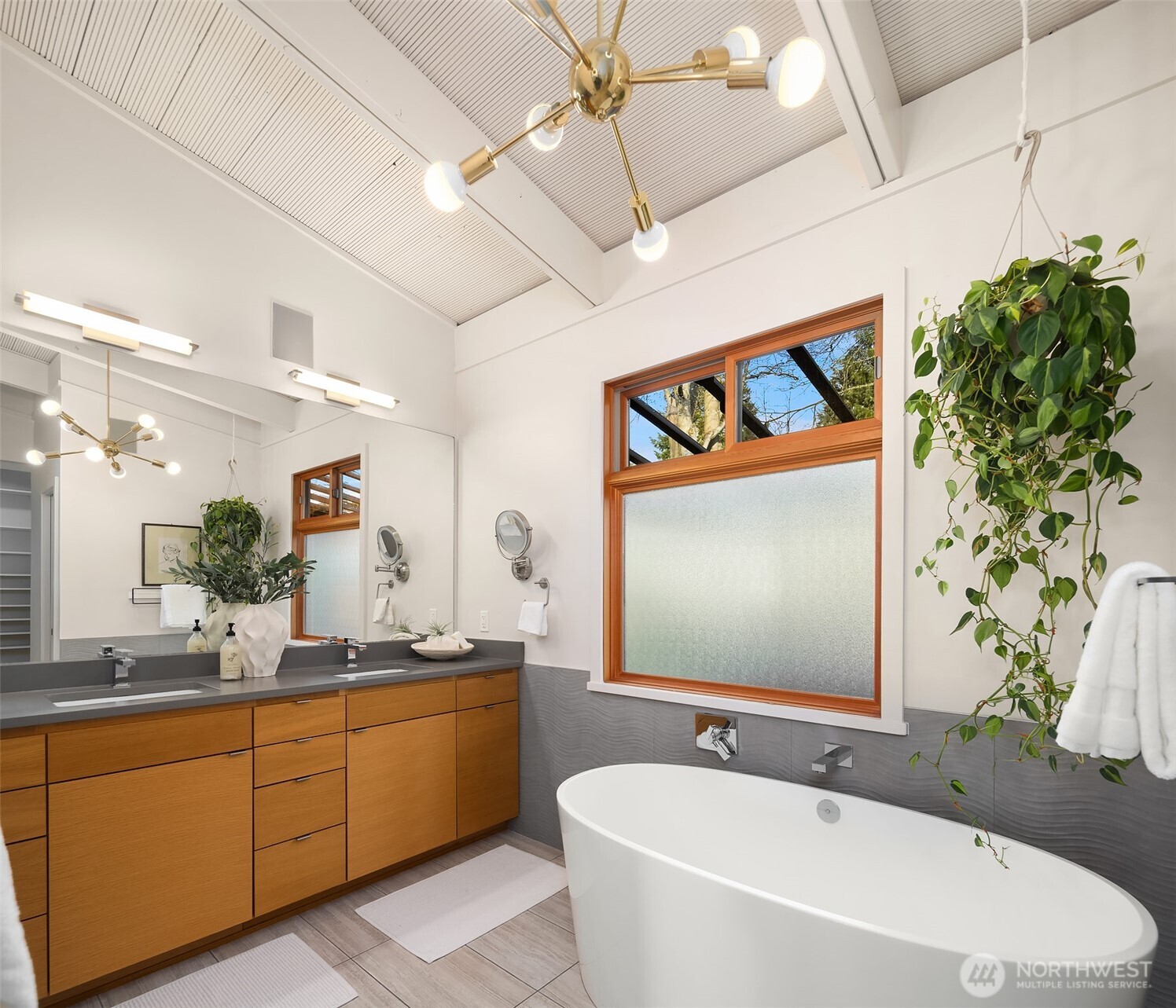 2826 Southwest 170th Street Burien, WA 98166 - Photo 21 of 40 a spacious bathroom with a double vanity sink a mirror and a bathtub
