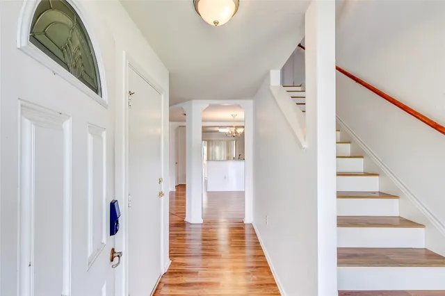 a view of a hallway with wooden floor and entryway