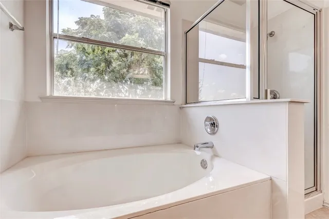 a bathroom with a bathtub and window
