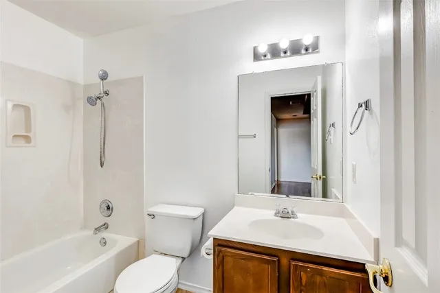 a bathroom with a sink toilet vanity and shower
