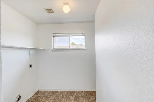 a backyard of a house with barbeque oven and outdoor seating