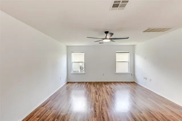 wooden floor in an empty room with a window