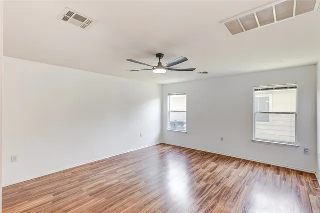 wooden floor in an empty room with a window