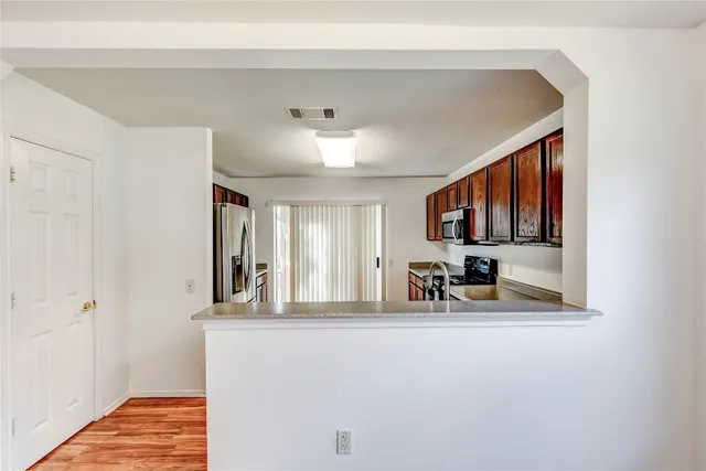 a view of living room with furniture and a flat screen tv