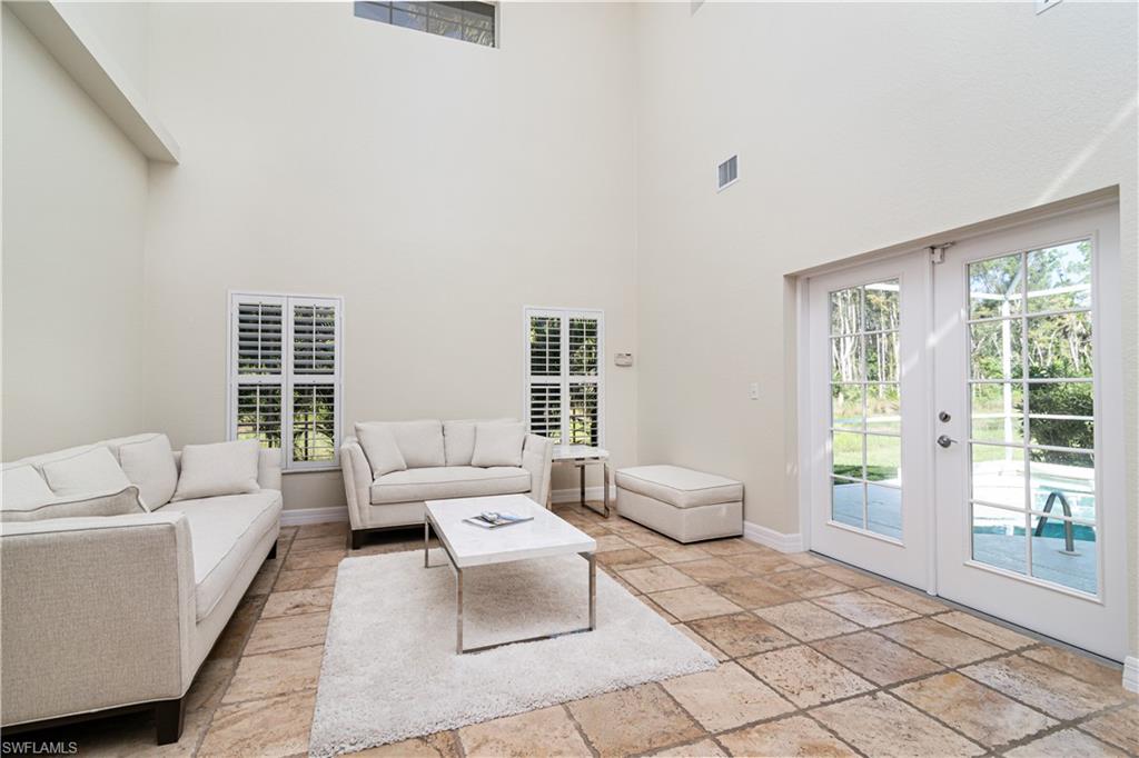 4049 Skyway Drive Naples, FL 34112 - Photo 12 of 31 a living room with furniture and a large window