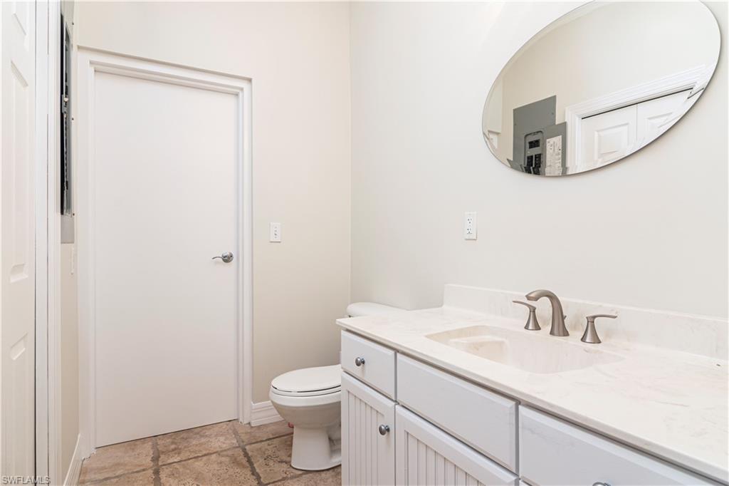 4049 Skyway Drive Naples, FL 34112 - Photo 15 of 31 a bathroom with a sink toilet and mirror