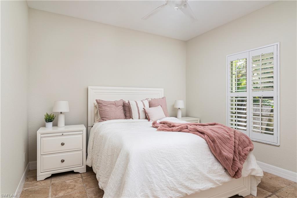 4049 Skyway Drive Naples, FL 34112 - Photo 16 of 31 a bedroom with a bed and a window