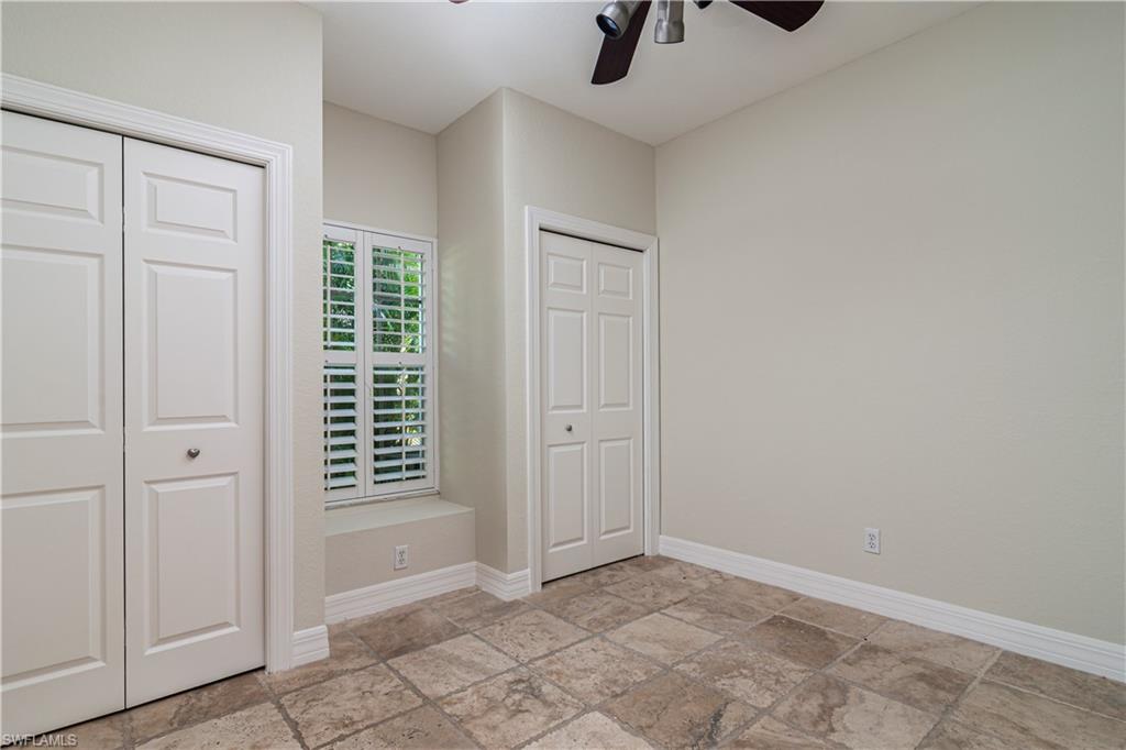 4049 Skyway Drive Naples, FL 34112 - Photo 19 of 31 an empty room with windows