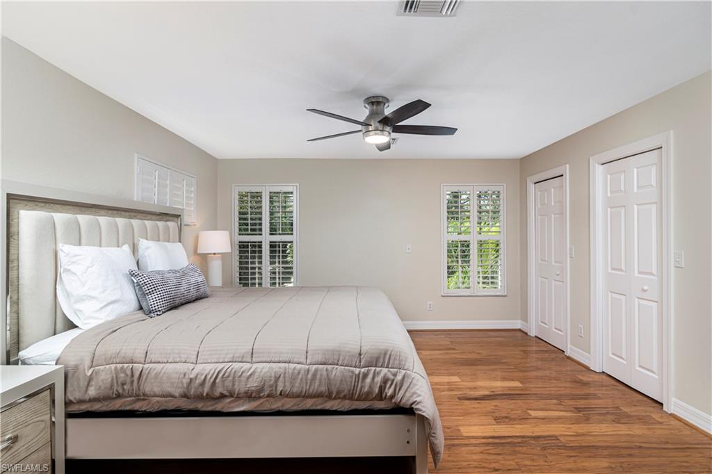 4049 Skyway Drive Naples, FL 34112 - Photo 20 of 31 a bedroom with a large bed and a window