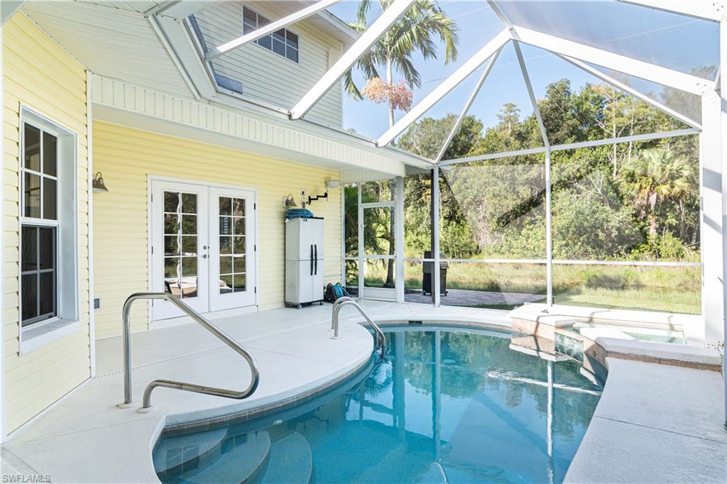 4049 Skyway Drive Naples, FL 34112 - Photo 6 of 31 a building outdoor space with patio furniture and potted plants