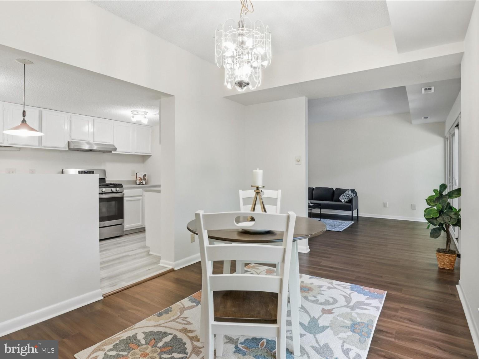 11809 Breton Court, Unit 2B Reston, VA 20191 - Photo 10 of 29 a kitchen with furniture wooden floor and a potted plant