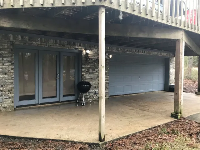 a backyard of a house with barbeque oven