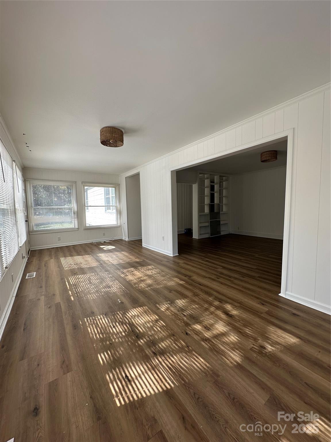 1215 Summerville Road, Unit 112 Charlotte, NC 28214 - Photo 11 of 20 a view of empty room with wooden floor and fan