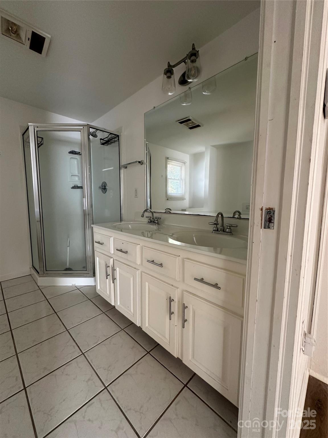 1215 Summerville Road, Unit 112 Charlotte, NC 28214 - Photo 13 of 20 a spacious bathroom with a shower a mirror and a sink