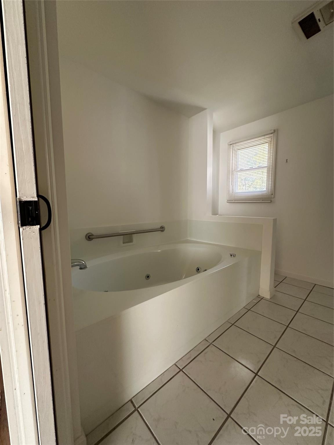 1215 Summerville Road, Unit 112 Charlotte, NC 28214 - Photo 14 of 20 a bathroom with a bathtub and shower