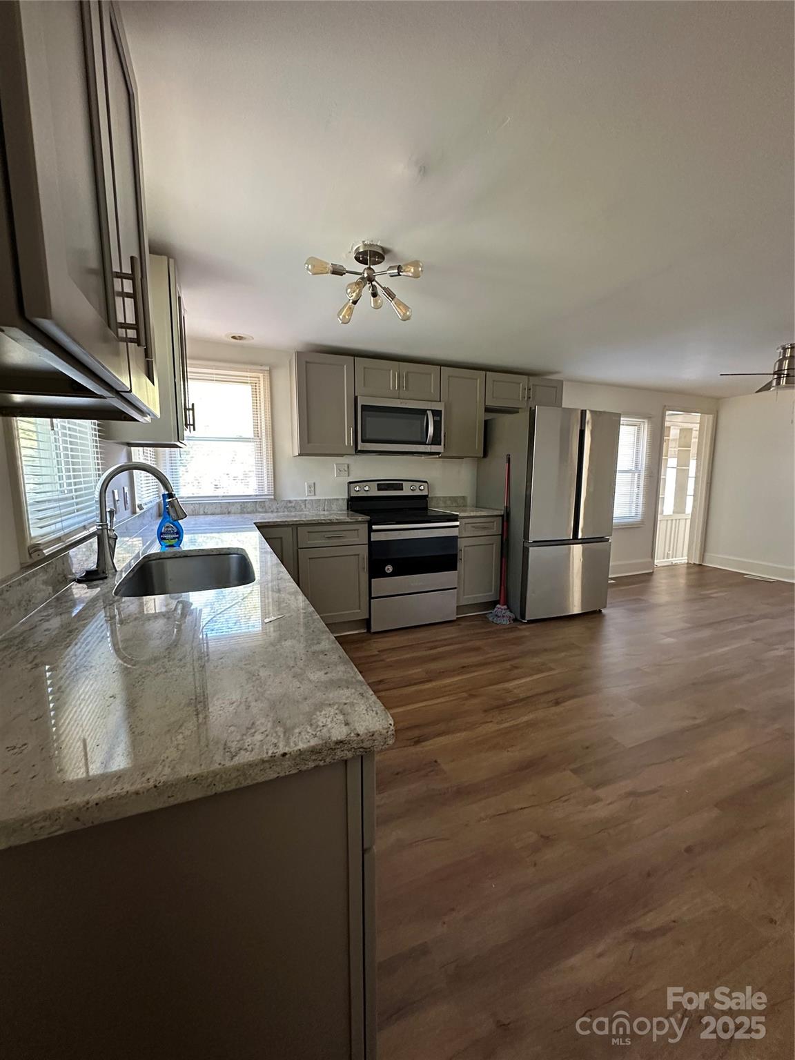1215 Summerville Road, Unit 112 Charlotte, NC 28214 - Photo 16 of 20 a kitchen with kitchen island a sink stainless steel appliances and cabinets