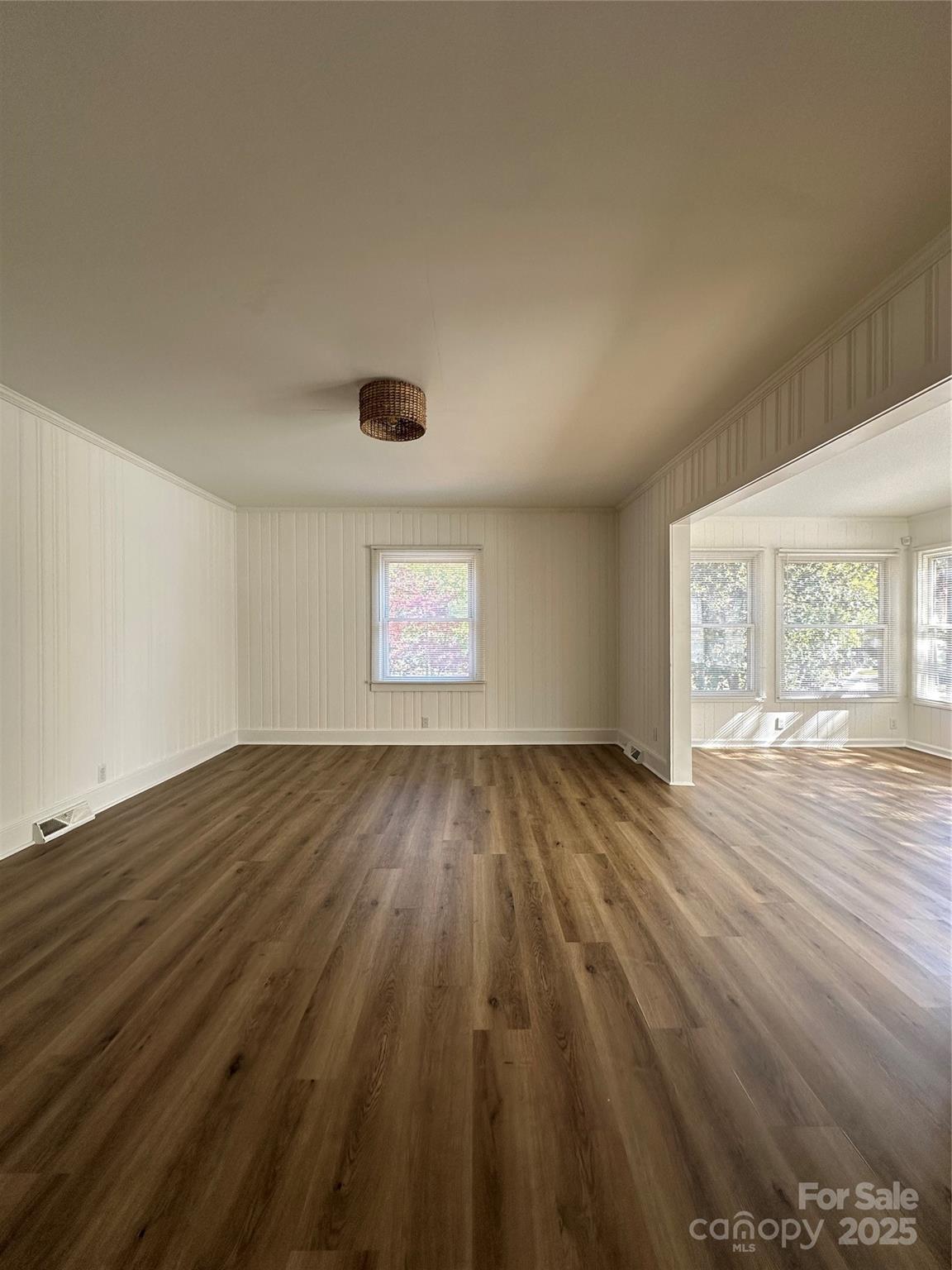 1215 Summerville Road, Unit 112 Charlotte, NC 28214 - Photo 6 of 20 an empty room with wooden floor and windows