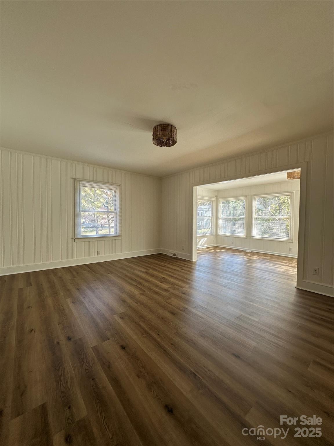 1215 Summerville Road, Unit 112 Charlotte, NC 28214 - Photo 7 of 20 an empty room with wooden floor and windows
