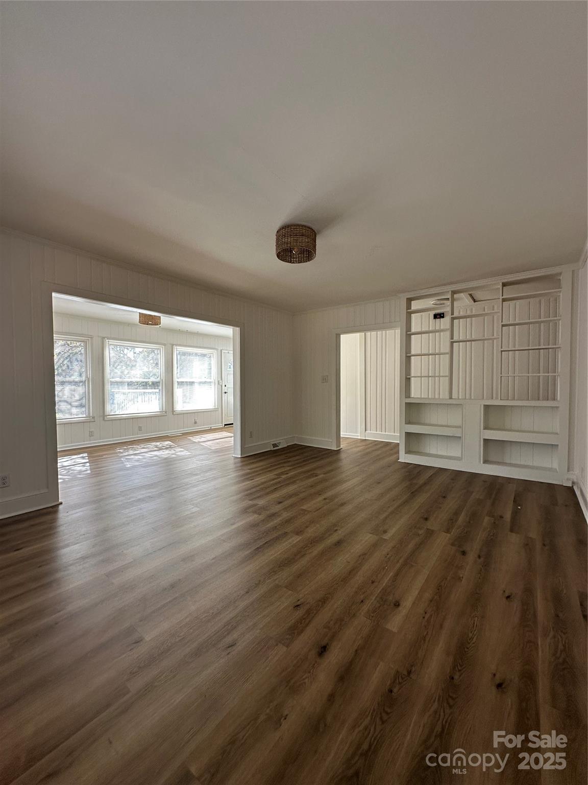 1215 Summerville Road, Unit 112 Charlotte, NC 28214 - Photo 8 of 20 an empty room with wooden floor and windows