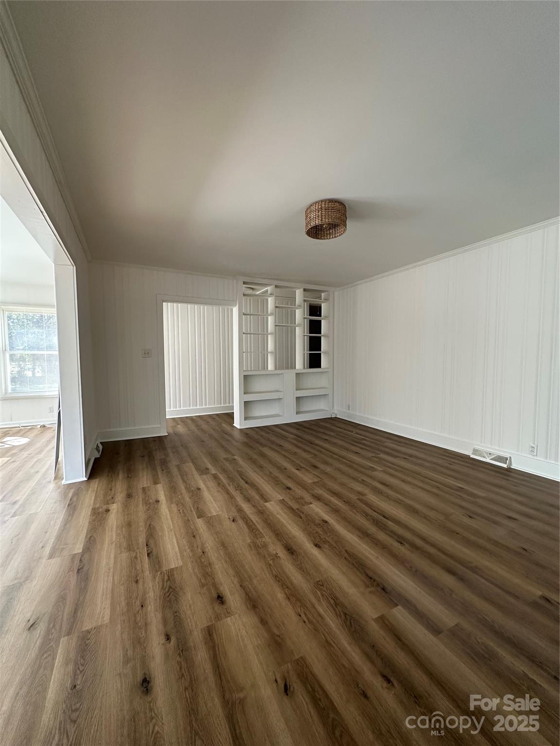 1215 Summerville Road, Unit 112 Charlotte, NC 28214 - Photo 9 of 20 an empty room with wooden floor and windows