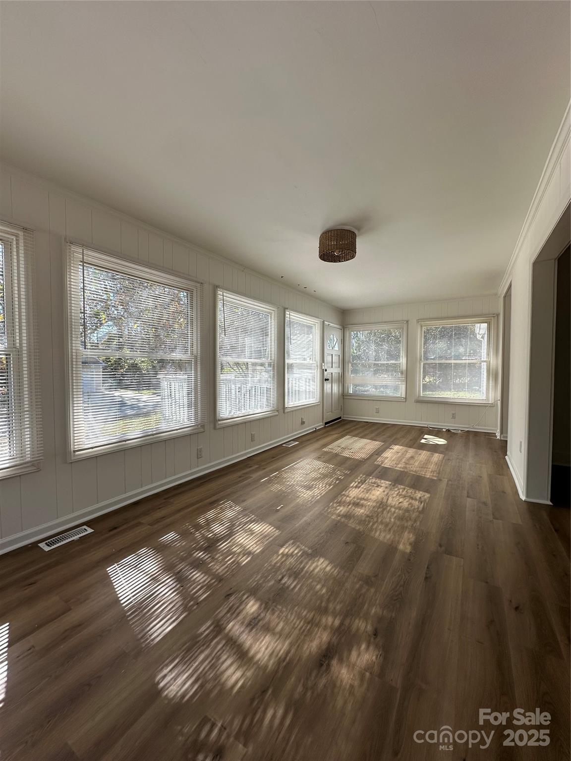 1215 Summerville Road, Unit 112 Charlotte, NC 28214 - Photo 10 of 20 a view of an empty room with a window and wooden floor