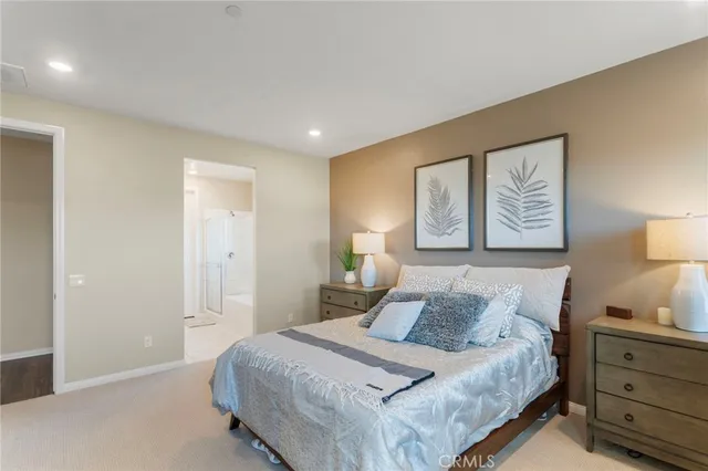 a bedroom with a bed and a lamp