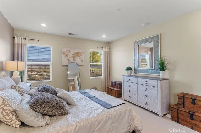 a bedroom with a large bed and a dresser