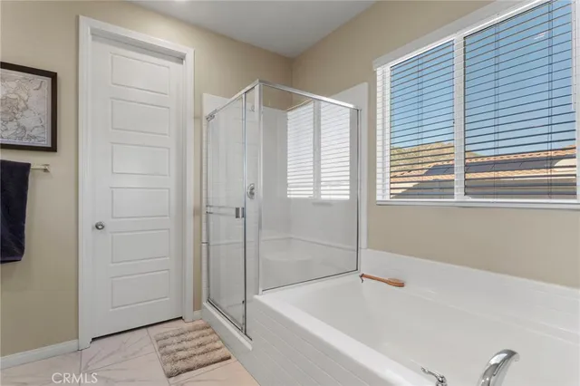 a bathroom with a bathtub and a shower