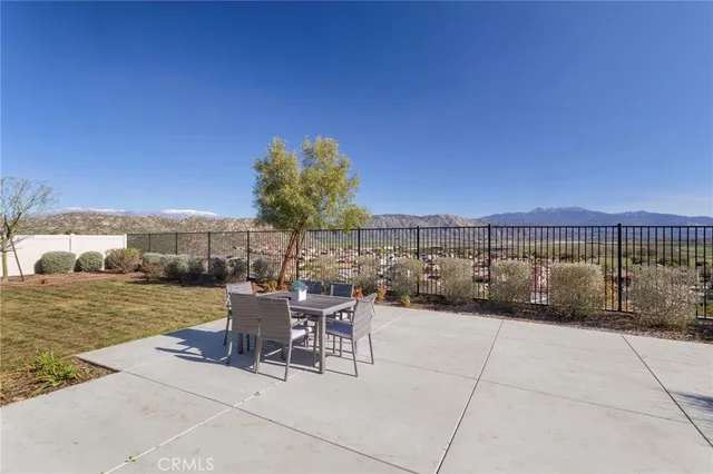 a view of a patio with a table and chairs and potted plants