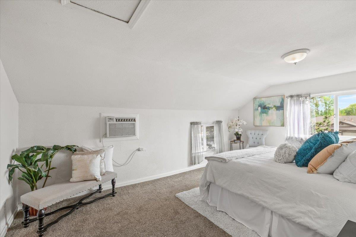 572 Pedersen Road Oakdale, CA 95361 - Photo 26 of 36 a bedroom with a bed a couch and potted plant on the dresser