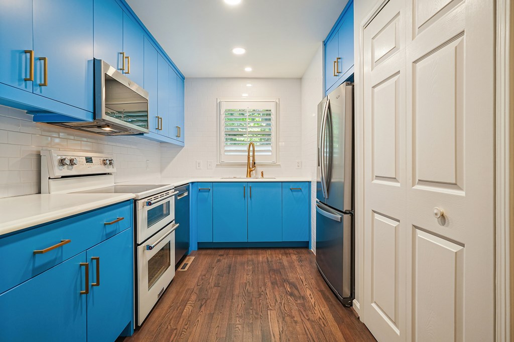 230 Chestnut Rise Trail Big Canoe, GA 30143 - Photo 16 of 45 a kitchen with stainless steel appliances granite countertop a refrigerator a sink dishwasher and wooden cabinets with wooden floor