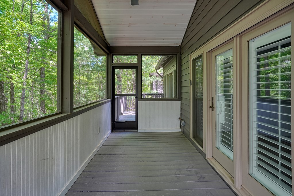 230 Chestnut Rise Trail Big Canoe, GA 30143 - Photo 40 of 45 a view of a porch with wooden floor and stairs