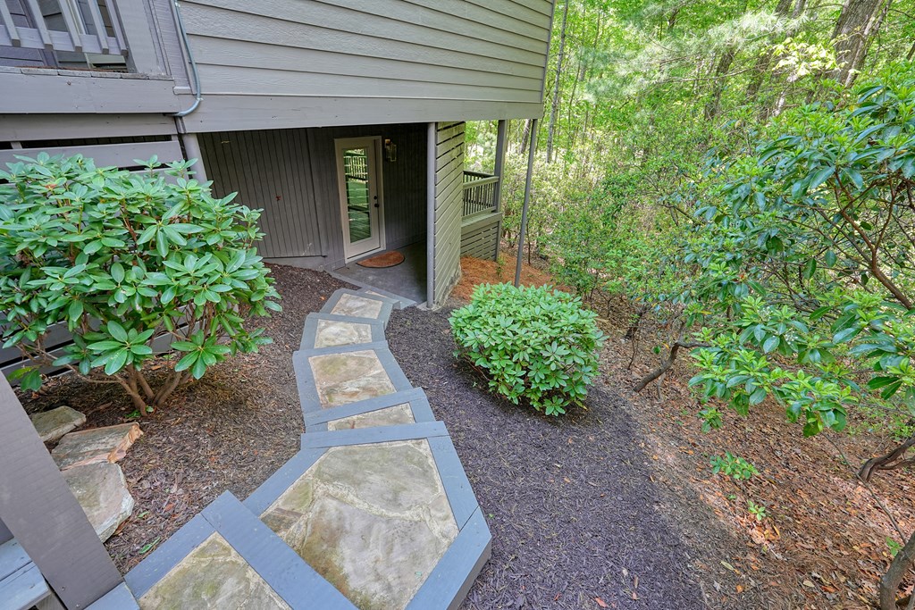230 Chestnut Rise Trail Big Canoe, GA 30143 - Photo 42 of 45 a front view of a house with garden