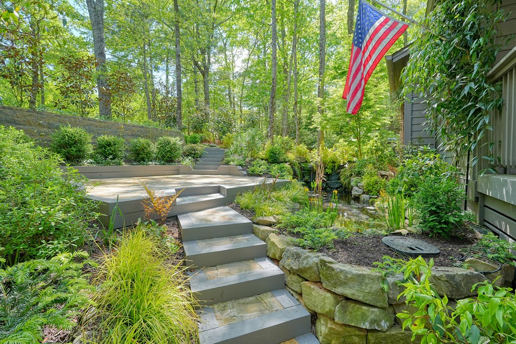 230 Chestnut Rise Trail Big Canoe, GA 30143 - Photo 44 of 45 a view of a backyard with plants and a fountain