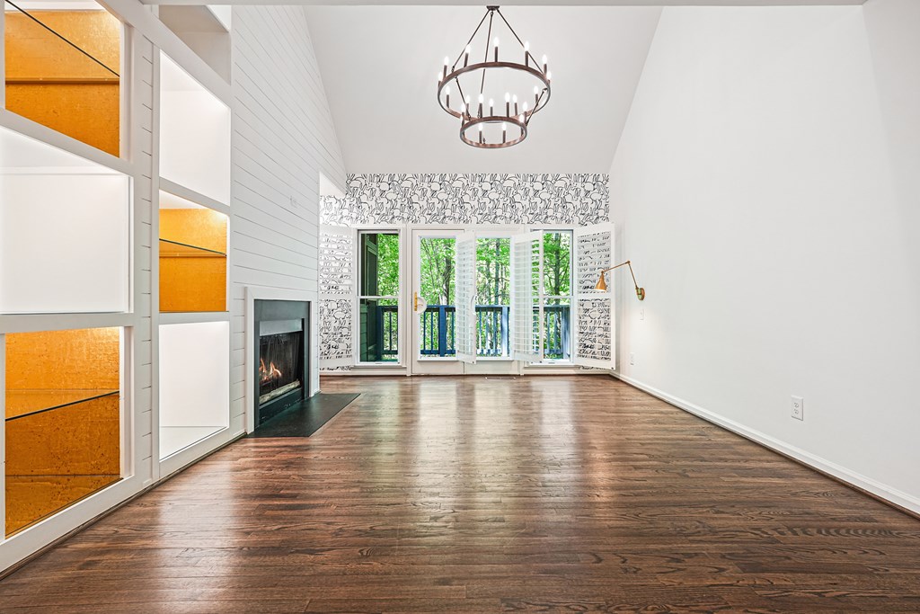 230 Chestnut Rise Trail Big Canoe, GA 30143 - Photo 10 of 45 an empty room with wooden floor fireplace and windows
