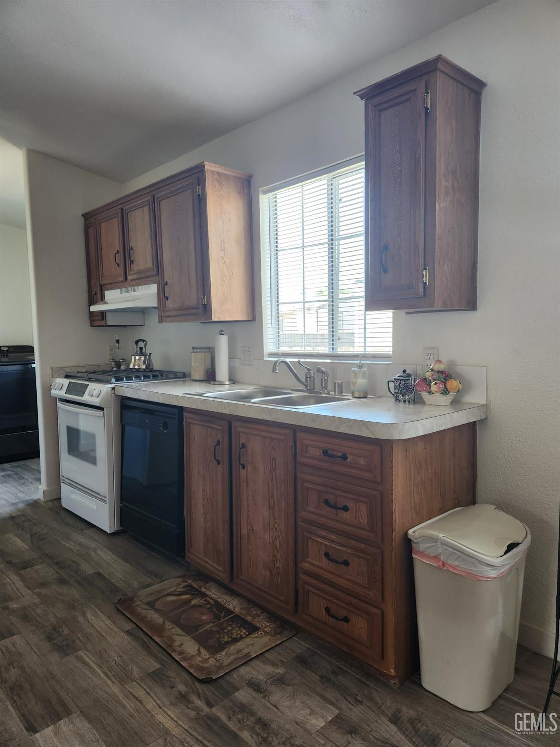 Undisclosed Address Bakersfield, CA 93314 - Photo 11 of 28 a kitchen with a sink a stove and cabinets