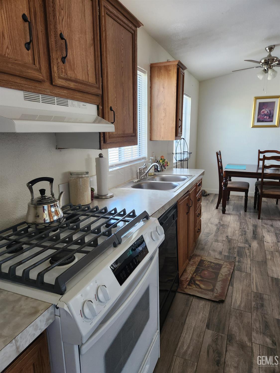 Undisclosed Address Bakersfield, CA 93314 - Photo 13 of 28 a kitchen with a stove and a sink