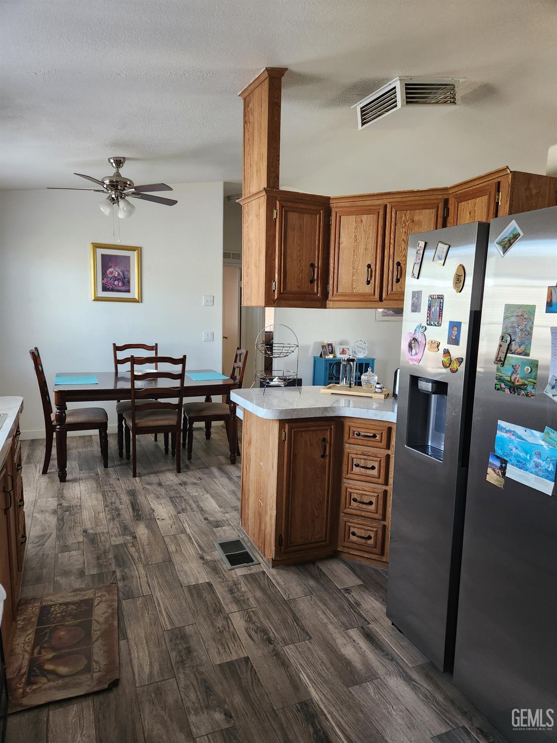 Undisclosed Address Bakersfield, CA 93314 - Photo 14 of 28 a kitchen with stainless steel appliances wooden floor and a refrigerator