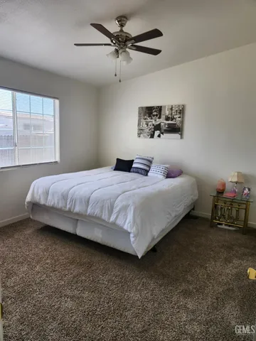 a bedroom with bed and window