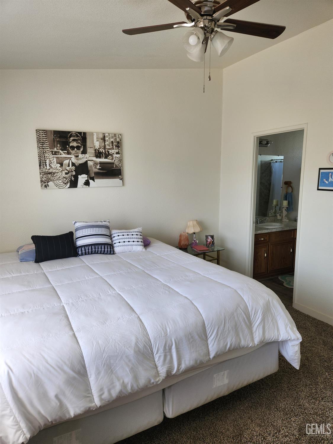 Undisclosed Address Bakersfield, CA 93314 - Photo 17 of 28 a bedroom with a bed and a chandelier