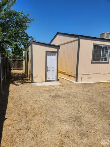a view of a backyard with wooden fence